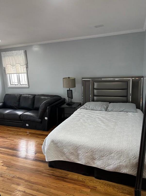 162-30 89th St, Howard Beach, NY 11414 - bedroom with wood finished floors and ornamental molding