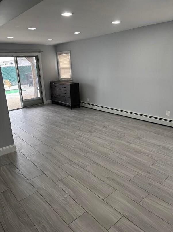 162-30 89th St, Howard Beach, NY 11414 - unfurnished room featuring a baseboard radiator, recessed lighting, baseboards, and wood finished floors