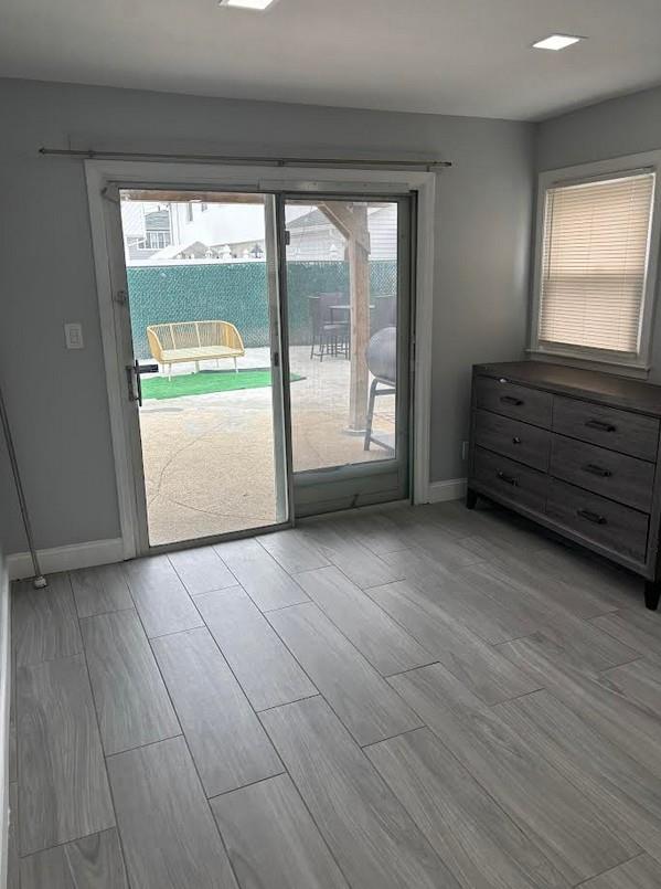 162-30 89th St, Howard Beach, NY 11414 - doorway to outside featuring baseboards, a wealth of natural light, and light wood finished floors