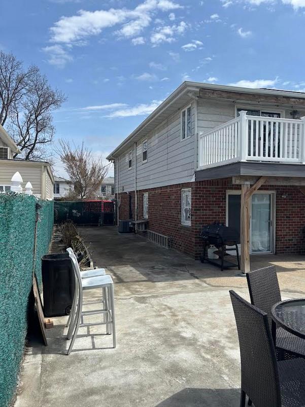 162-30 89th St, Howard Beach, NY 11414 - exterior space featuring a fenced backyard and a balcony