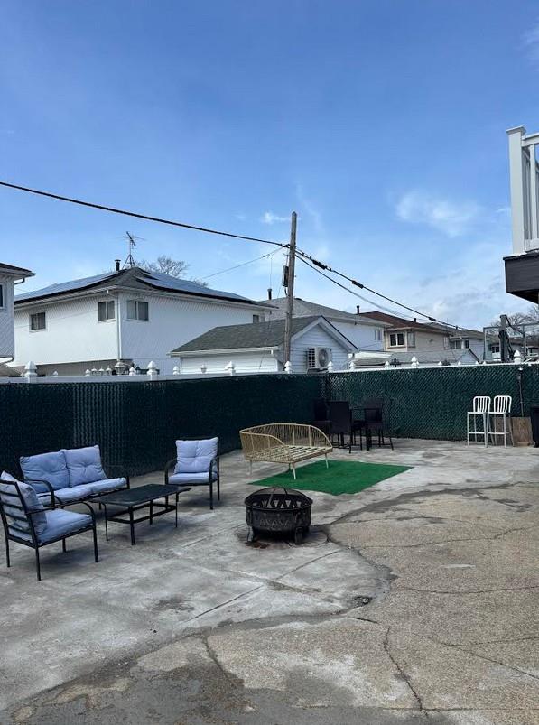 162-30 89th St, Howard Beach, NY 11414 - view of patio / terrace with fence and an outdoor living space with a fire pit