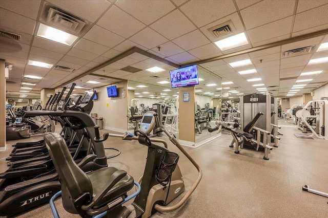 gym with visible vents and a paneled ceiling