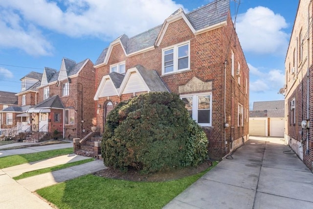 view of front of home featuring a garage, a residential view, and brick siding