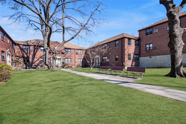 view of property's community with a lawn