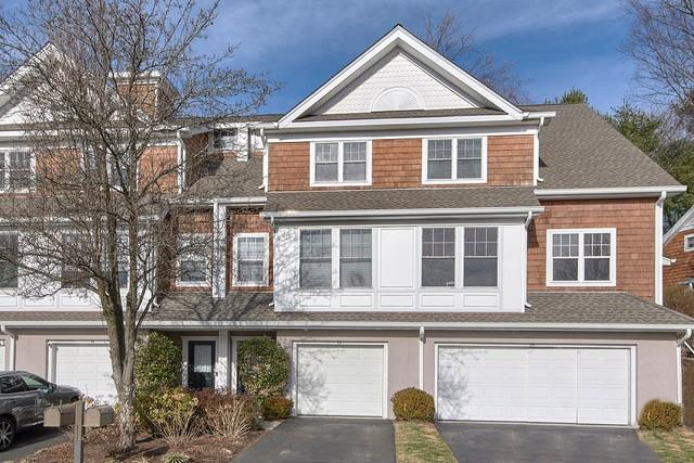 view of front of house featuring a garage, driveway, and a shingled roof