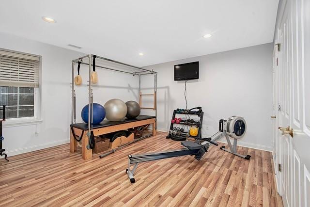 exercise room featuring recessed lighting, baseboards, and wood finished floors