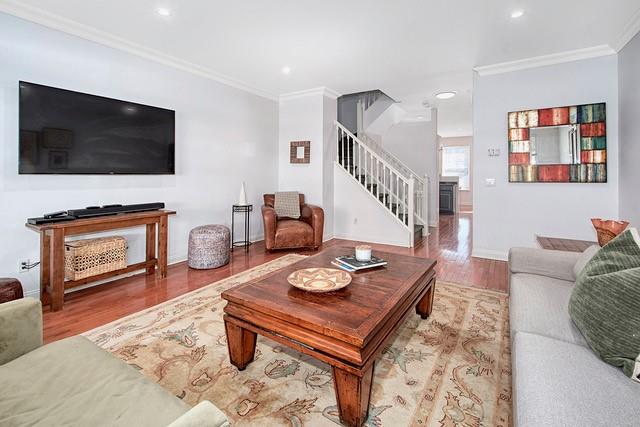 living room with stairs, recessed lighting, wood finished floors, and ornamental molding