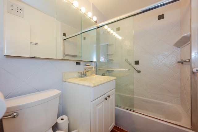 full bathroom with toilet, shower / bath combination with glass door, tile walls, decorative backsplash, and vanity