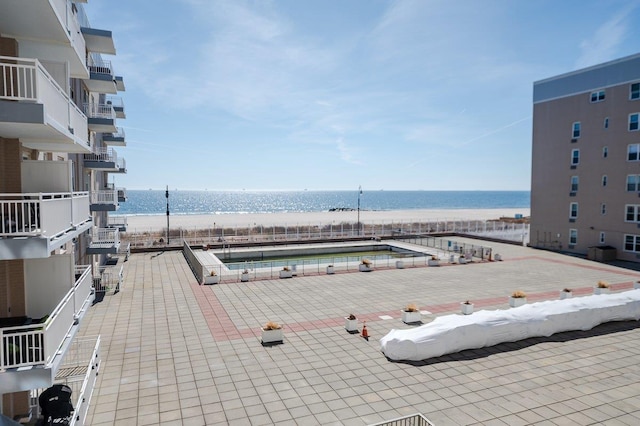 view of pool with a water view