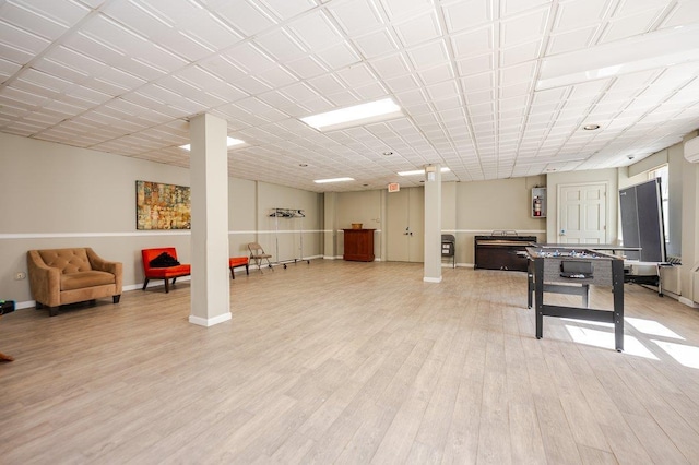 rec room featuring light wood-style flooring and baseboards