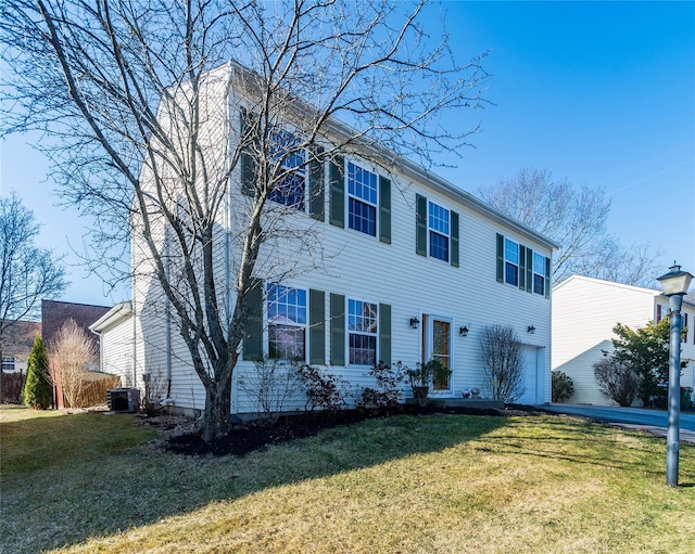 colonial-style house featuring a garage, central AC unit, and a front lawn