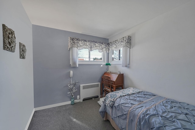 bedroom with radiator, baseboards, and carpet floors