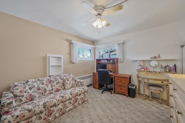 office featuring light carpet, radiator, and ceiling fan