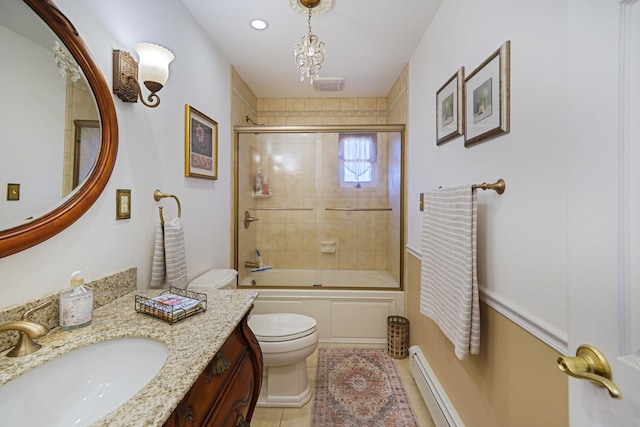 bathroom with a baseboard heating unit, toilet, tile patterned floors, combined bath / shower with glass door, and vanity