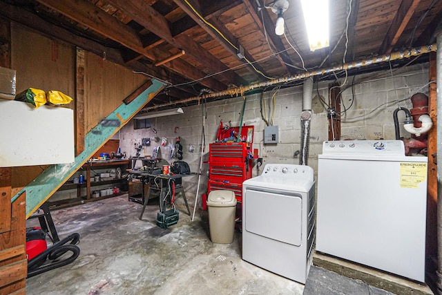 unfinished basement with a workshop area and washing machine and clothes dryer