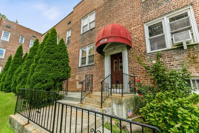 view of exterior entry featuring brick siding