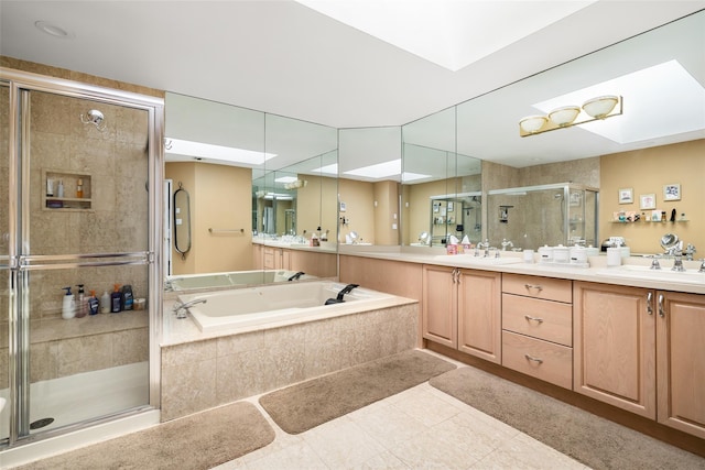 bathroom featuring a shower stall, a garden tub, double vanity, and a sink