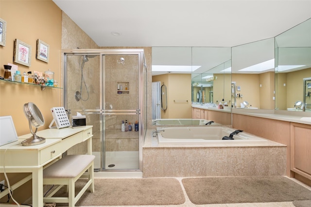 bathroom featuring vanity, a bath, and a stall shower