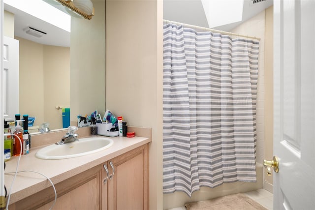 full bathroom featuring tile patterned floors, visible vents, vanity, and shower / tub combo with curtain