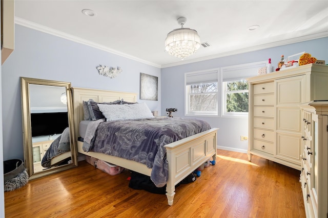 bedroom featuring visible vents, crown molding, light wood finished floors, baseboards, and a chandelier