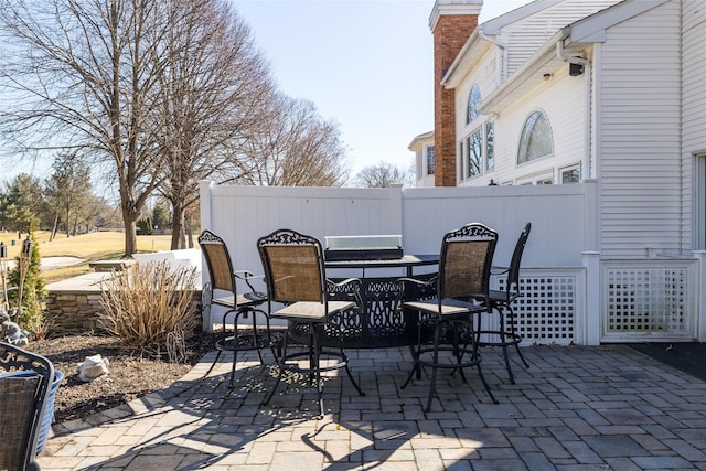 view of patio with outdoor dining space and fence