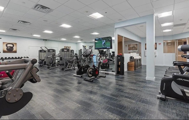 workout area with visible vents, a drop ceiling, and carpet floors