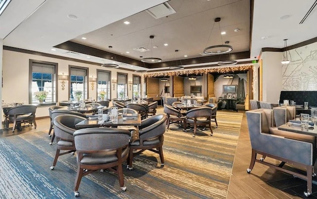 dining room featuring recessed lighting, visible vents, a raised ceiling, and crown molding