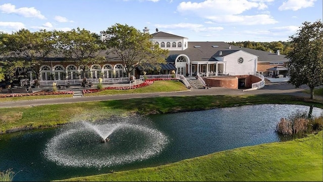 exterior space featuring a yard and a water view