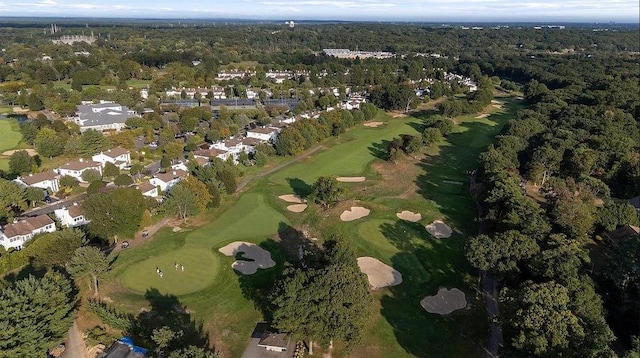 drone / aerial view featuring view of golf course and a wooded view