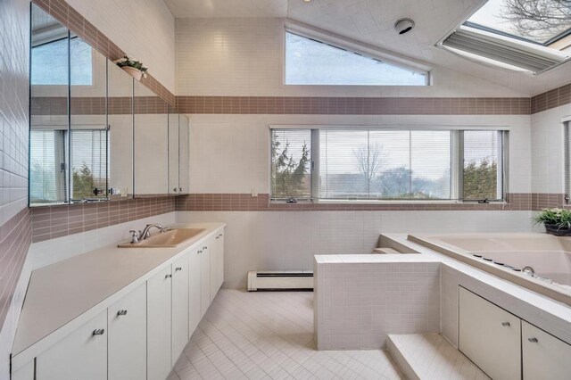 full bath with tile patterned flooring, tile walls, a garden tub, and a baseboard radiator