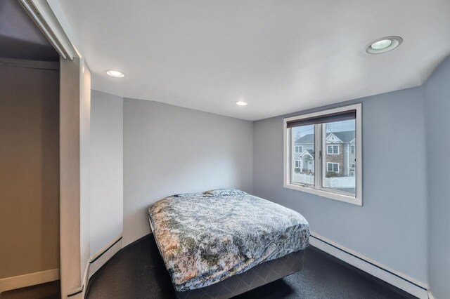 bedroom featuring recessed lighting and baseboard heating