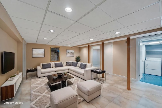 living area with recessed lighting, washing machine and dryer, and a drop ceiling