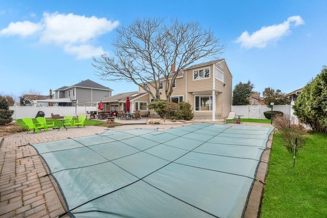 view of pool featuring a fenced in pool, a patio, a fenced backyard, and outdoor dining space