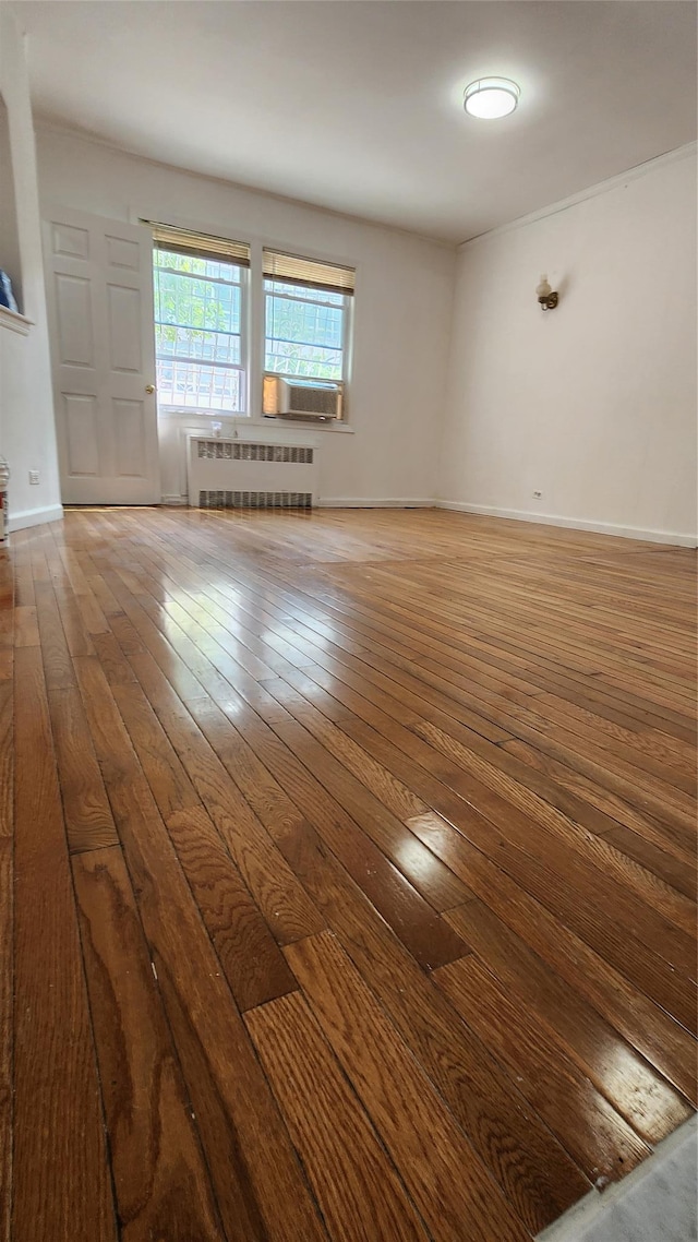 149-03 Reeves Ave, Flushing, NY 11367 - unfurnished room with radiator heating unit and hardwood / wood-style flooring