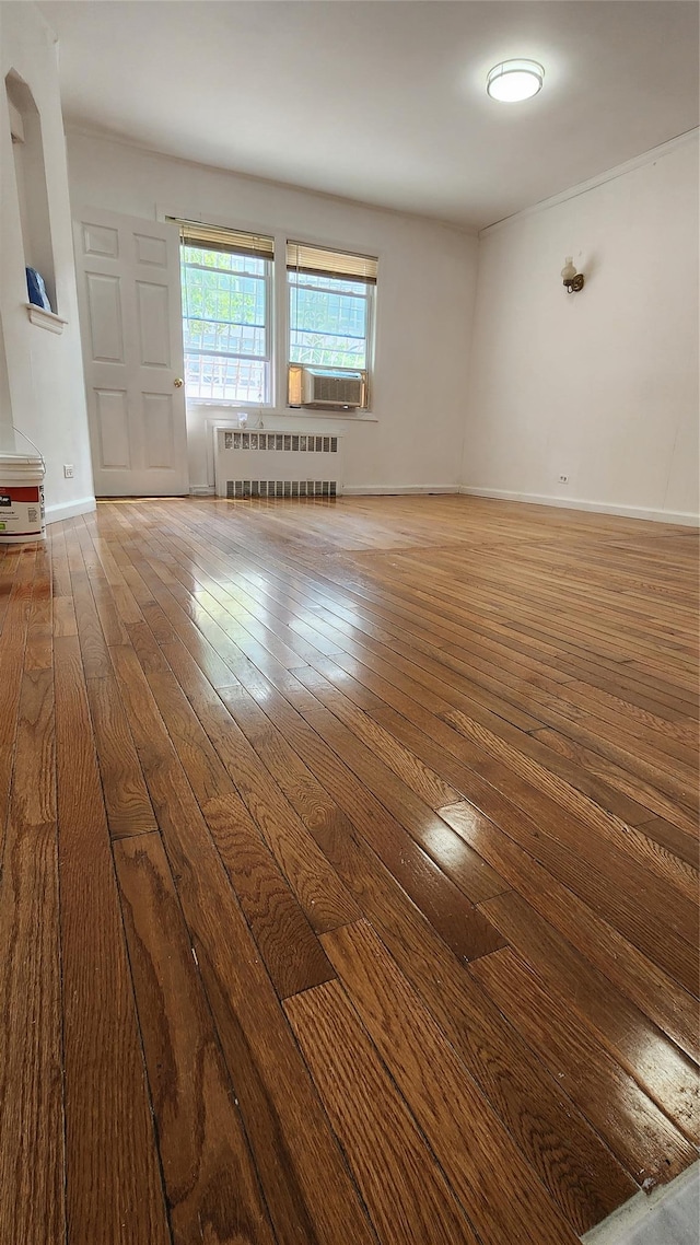 149-03 Reeves Ave, Flushing, NY 11367 - empty room featuring radiator heating unit, hardwood / wood-style flooring, and cooling unit