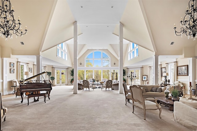 living room featuring a chandelier, visible vents, a high ceiling, and carpet