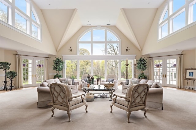 living area with carpet, french doors, and a towering ceiling