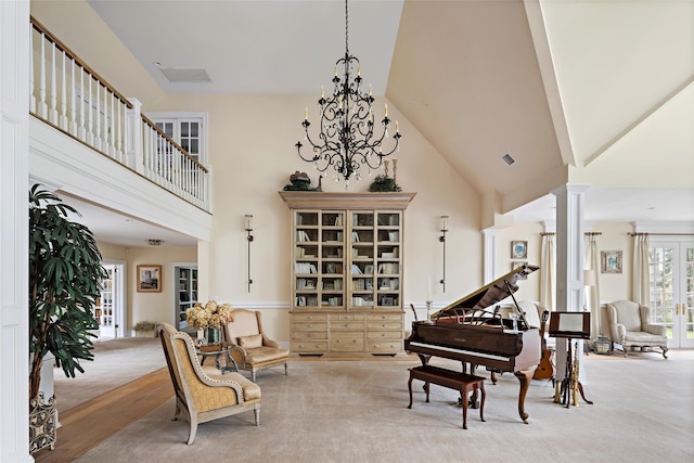 sitting room with carpet and high vaulted ceiling