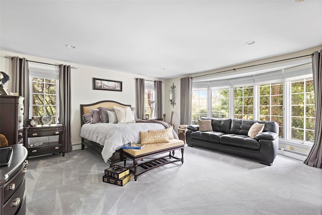 bedroom with recessed lighting, a baseboard heating unit, and carpet floors