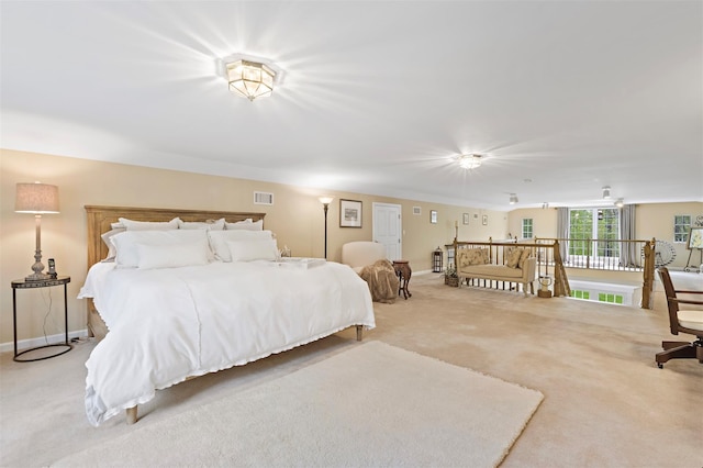 bedroom with visible vents, light colored carpet, and baseboards