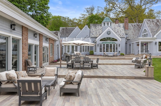 wooden deck featuring outdoor dining space, french doors, and outdoor lounge area