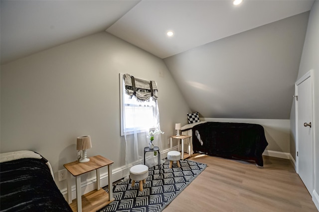 interior space featuring wood finished floors, baseboards, a baseboard radiator, lofted ceiling, and recessed lighting