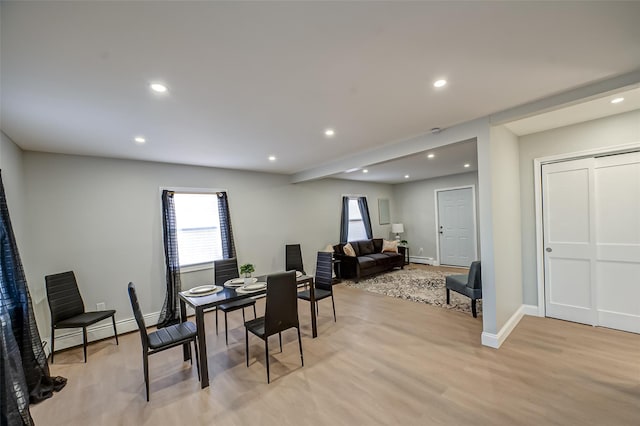 dining space featuring a baseboard heating unit, recessed lighting, light wood-type flooring, and baseboards