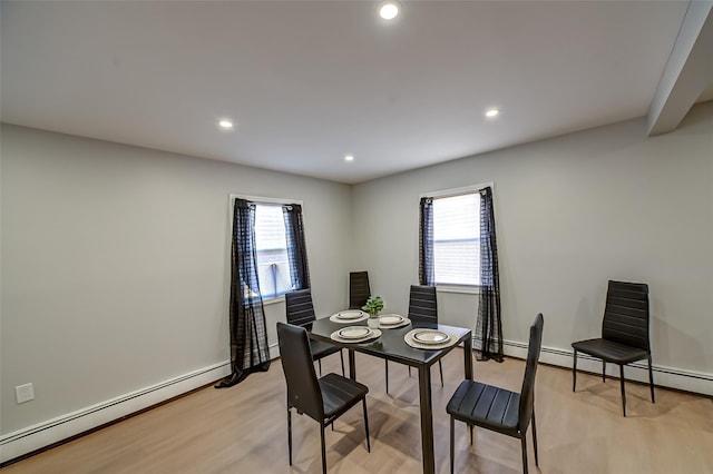 dining area with recessed lighting, light wood-type flooring, a wealth of natural light, and a baseboard radiator