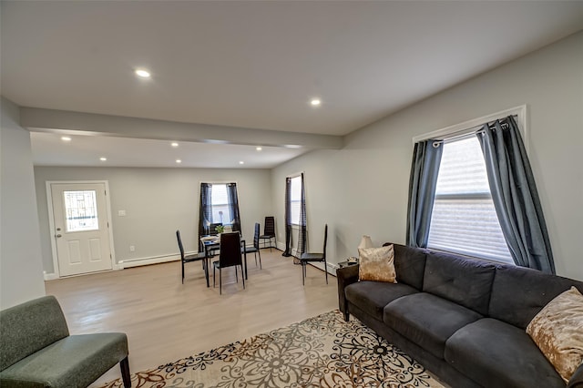 living area featuring recessed lighting, baseboards, light wood finished floors, and a baseboard radiator