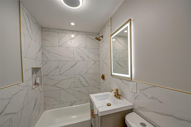 bathroom with toilet, recessed lighting, shower / bathing tub combination, tile walls, and vanity