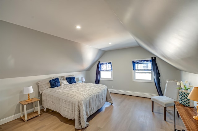 bedroom with wood finished floors, baseboards, a baseboard radiator, recessed lighting, and vaulted ceiling