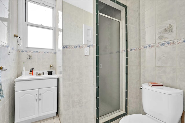 full bathroom featuring vanity, tile walls, a shower stall, and toilet