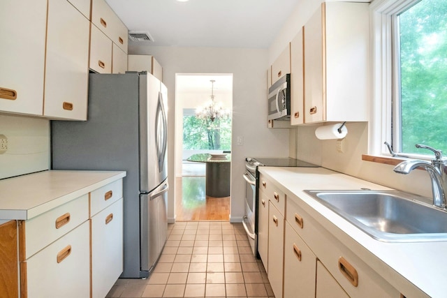 707 Eagle Bay Dr, Ossining, NY 10562 - kitchen featuring stainless steel appliances, a sink, light countertops, and healthy amount of natural light