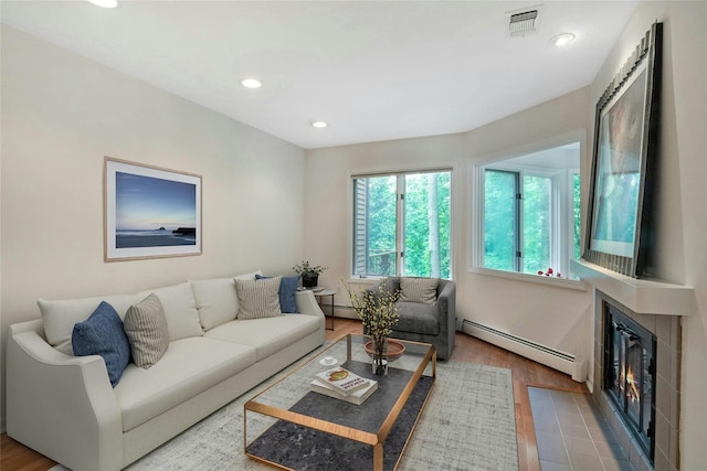 707 Eagle Bay Dr, Ossining, NY 10562 - living room with baseboard heating, wood finished floors, recessed lighting, and a glass covered fireplace